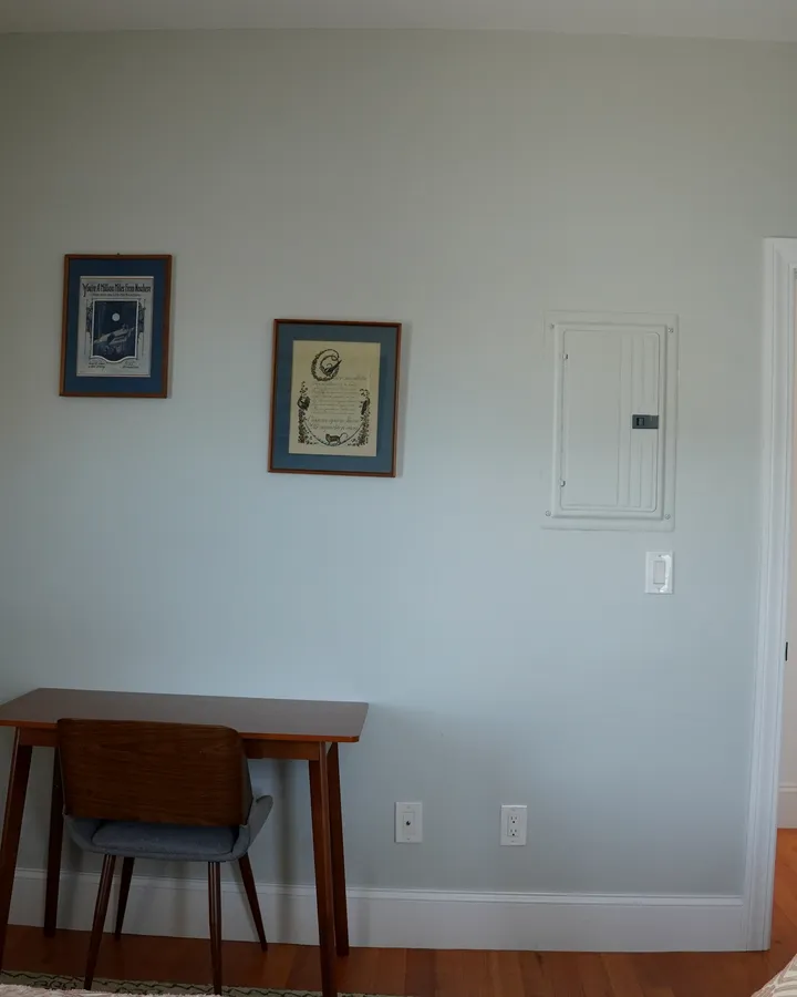 Before: the same bedroom, with the old electrical panel by the door
