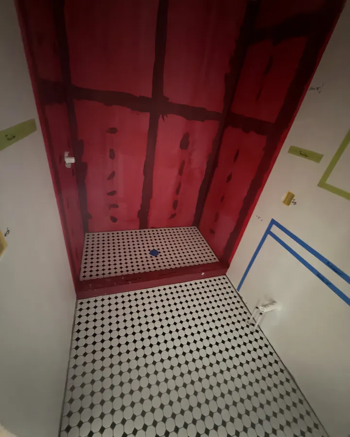 During: waterproofed shower walls and the octagon tile floor going down